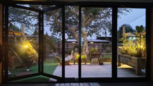 The finished catio at dusk with the lighting